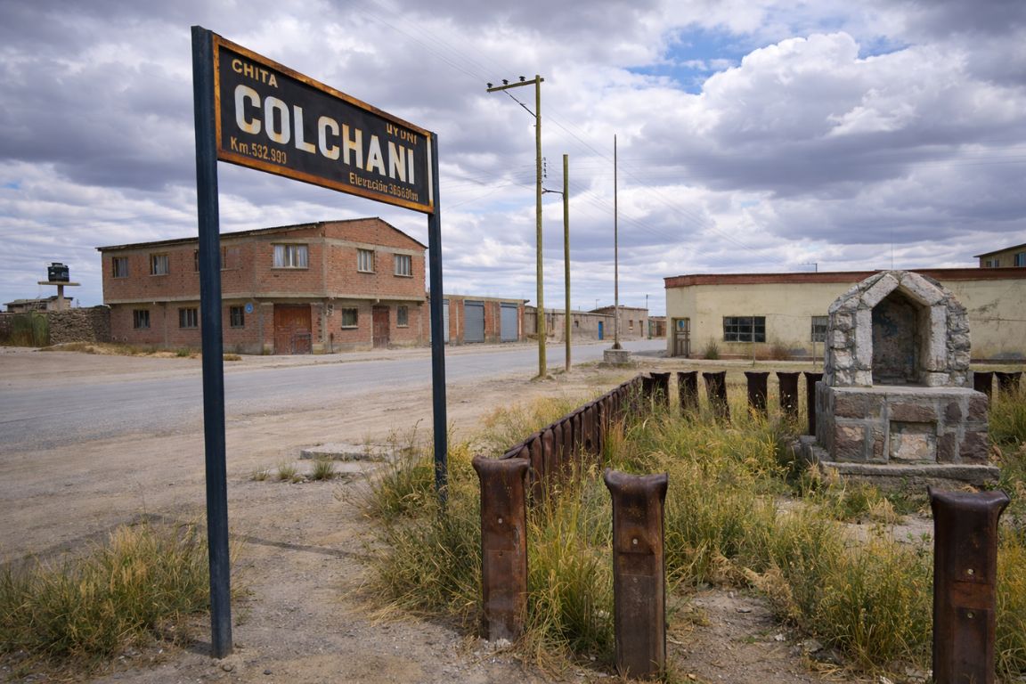 Colchani village in Bolivia with roadside sign and small town buildings close to Salar de Uyuni, seen during a guided tour with Salar de Uyuni Tours